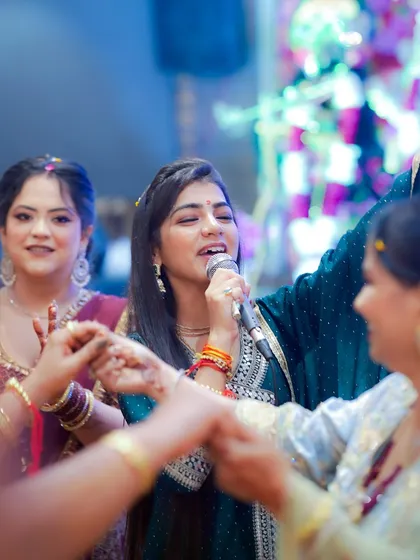 Engaging with the audience during a bhajan performance. I believe in creating an interactive experience where everyone feels part of the divine celebration.