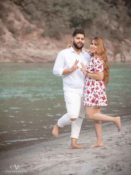 A fun and quirky pose from the couple during their riverside pre-wedding shoot, showing their playful side.