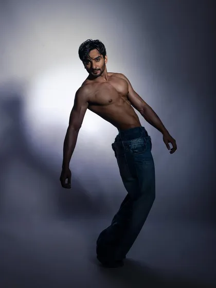 A dynamic, high-contrast studio portrait of a male model. I direct models to create expressive, powerful poses that show range and confidence, perfect for building a strong portfolio.