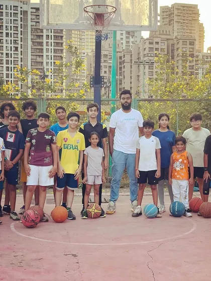 Hoops, heart, and hustle. A training session is complete, and our young ballers pose for a group photo with their coach. Together, we rise.