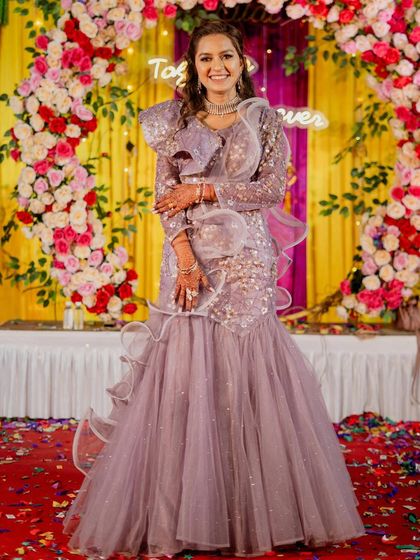Another shot of the lavender fish-cut lehenga, showcasing its shimmering details and flattering silhouette. This is a popular rental for its modern and elegant design.