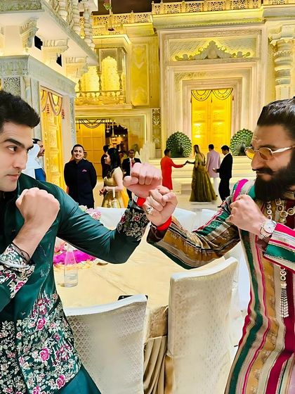 A powerful shot of Vijender Singh with Ranveer Singh, both making strong style statements. Vijender's embroidered silk kurta and velvet jacket stand out with refined elegance.
