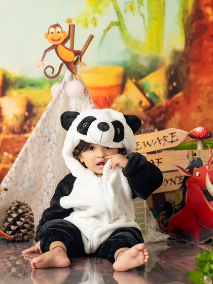 Dressed as an adorable panda for his 'Wild One' birthday theme, this little guy is ready for his jungle adventure. We have a wide variety of costumes for our themed shoots.