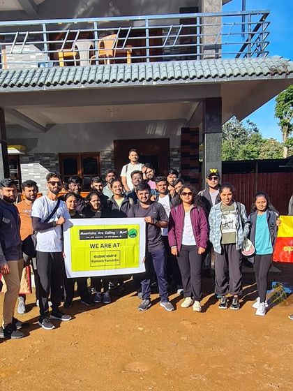 Our Kumara Parvatha batch, holding our banner and the Kannada flag, ready to start the trek from the homestay.