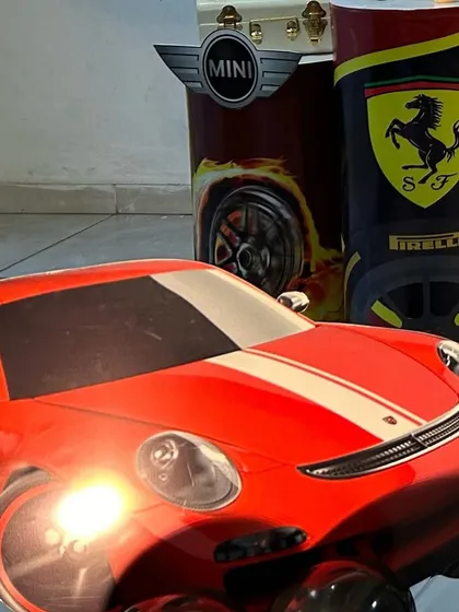 A large cutout of a Porsche, a key prop in a car-themed birthday party.
