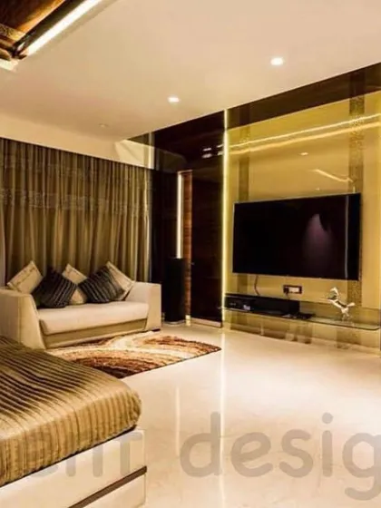 This expansive master bedroom is designed as a suite, with a dedicated seating area in addition to the bed. The use of dark, reflective surfaces and warm lighting creates a moody and luxurious hotel-like feel.