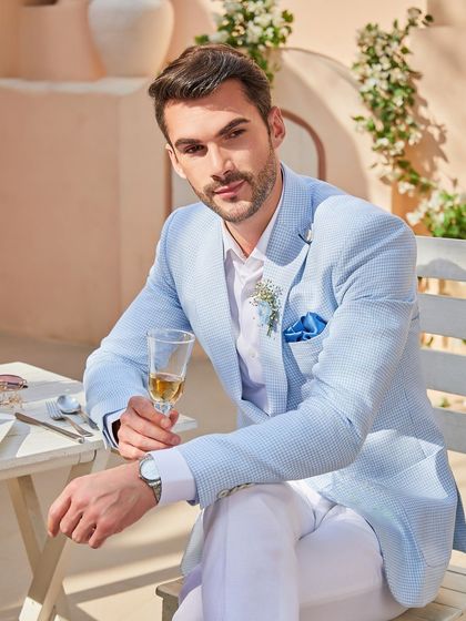 A serious style alert. This close-up shows the texture of the Arctic Blue linen fabric. It's a versatile jacket that works for a power lunch or a weekend party.