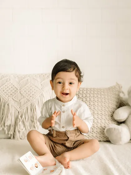 Clapping with excitement! This little one is so proud of his reading skills.