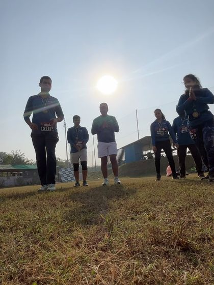 A silhouette shot of runners against the morning sun at the Aravali Trail Run venue.