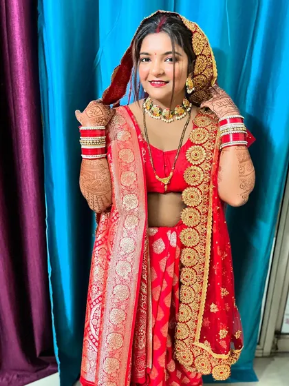 A radiant bride in her red wedding attire. Her hands, adorned with my intricate mehndi, complete her traditional and beautiful look.