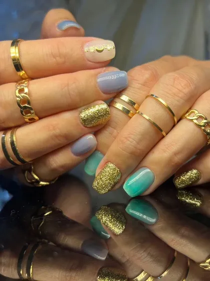 A full view of the stylish multi-colored and glittery nail set.