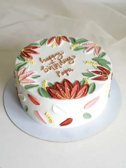 A birthday cake for "Papa" featuring hand-painted lotus flowers. I used a palette knife to create the petals, giving the design a beautiful, impressionistic texture.