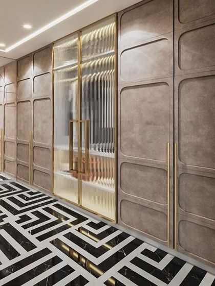 A walk-in closet with a mix of open and closed storage. The design features fluted glass doors, textured panels, and a bold geometric floor.