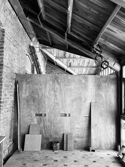 A work in progress shot of a new project. The raw textures of the existing building are met with the clean lines of new wooden partitions, hinting at the transformation to come.