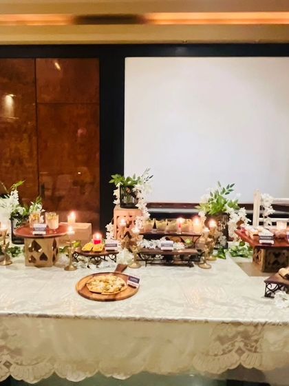 A wide shot of the buffet table, showing the full arrangement against a clean backdrop. This highlights the scale and elegance of the catering setup for a special occasion.