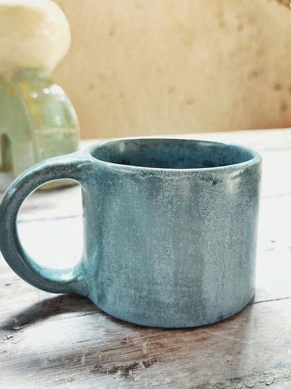 After her beginner's course, this student rejoined for the advanced level. She created beautiful wheel-thrown mugs and bowls, and also explored sculptural hand-building, creating this unique candlestick holder.