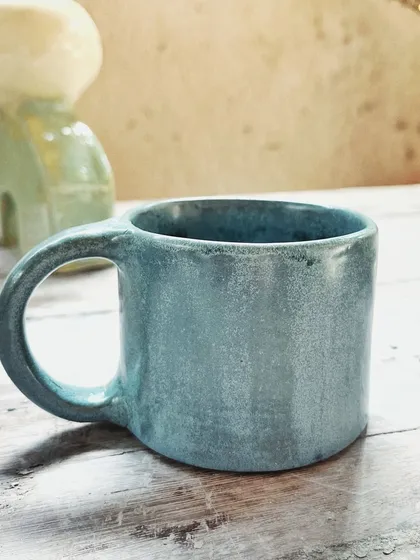 After her beginner's course, this student rejoined for the advanced level. She created beautiful wheel-thrown mugs and bowls, and also explored sculptural hand-building, creating this unique candlestick holder.