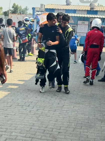 A celebratory hug between two teammates after a successful race.