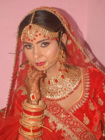 A confident portrait of the bride. The makeup is bold and beautiful, with a focus on defined eyes and lips.