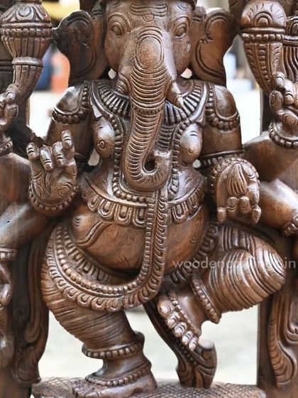A close-up of our 39-inch dancing Ganesha Jali work wall mount. The focus is on the deity's expressive face and torso, carved with incredible detail.