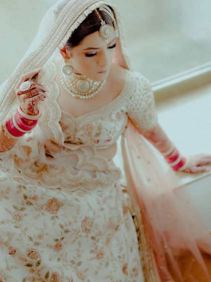 Our gorgeous bride Bhavya looking serene in her white floral lehenga and our unique pearl choker set.