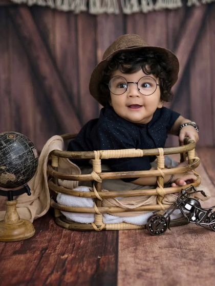 A little scholar in the making. The addition of glasses adds a touch of fun and whimsy to this adorable six-month milestone session.