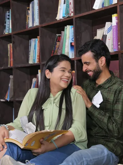 Another scene from the pre-wedding shoot, this time in a library setting. The natural makeup look is versatile enough to work across multiple themes and locations.