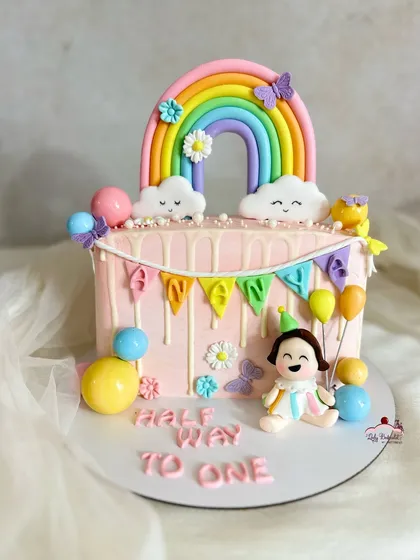 Half a year, but a whole lot of love! A sweet "Halfway to One" cake with a rainbow, clouds, and a custom figurine for a baby girl.