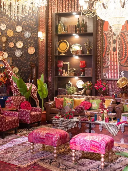 Every corner tells a story. In this Indian speakeasy-themed lounge, I layered rich textures, bespoke furniture, and eclectic artifacts like this life-sized giraffe to create a space that felt curated, personal, and full of secrets waiting to be discovered.