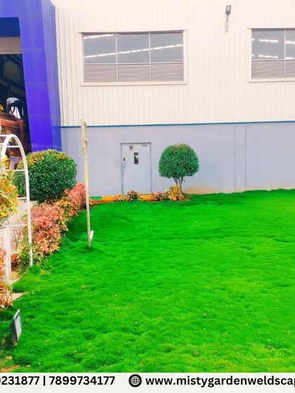 A beautifully manicured commercial landscape featuring a lush lawn, neatly trimmed shrubs, and ornamental trees. This creates a professional and welcoming first impression.