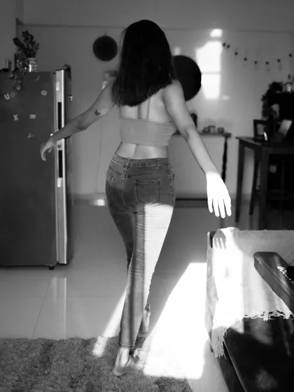 An indoor series using shadows from a window to create patterns on the subject. This shows a creative approach to using natural light in a domestic setting.