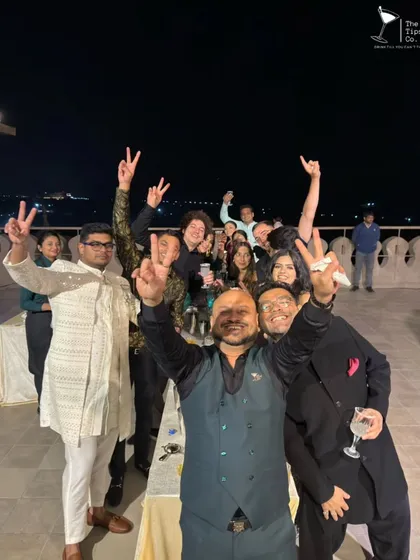 A celebratory group photo at the end of a successful cocktail workshop. The smiles and peace signs say it all; it was a fun and memorable experience for everyone.