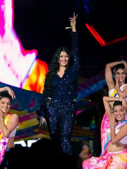 A dynamic performance featuring a lead singer and dancers in vibrant costumes. We manage all aspects of the on-stage talent, including choreography and wardrobe.