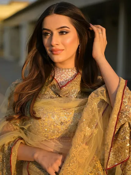 A golden hour moment. The soft, natural light makes her flawless makeup look even more radiant. This is a perfect, natural glam for any pre-wedding event.