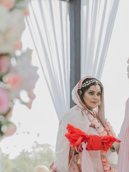 The bride and groom performing a wedding ritual together, a symbol of their partnership. Our focus is on the details and emotions of these significant traditions.