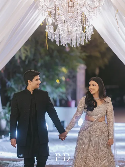 The couple's entrance under a grand crystal chandelier. Simple, elegant, and incredibly romantic, this is a timeless way to make an entrance.