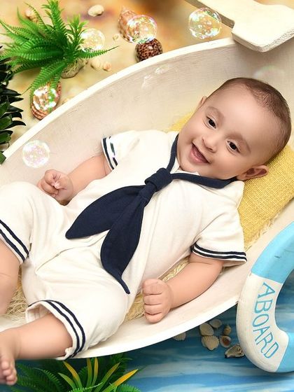 A big, happy smile from our little sailor. This boat-themed milestone shoot is a fun way to document your baby's four-month achievements.