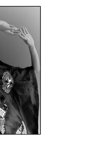 A black and white composition for Sheetal Zaveri, using negative space and a strong pose. The minimalist frame draws attention to the model's form and the embellished clothing.