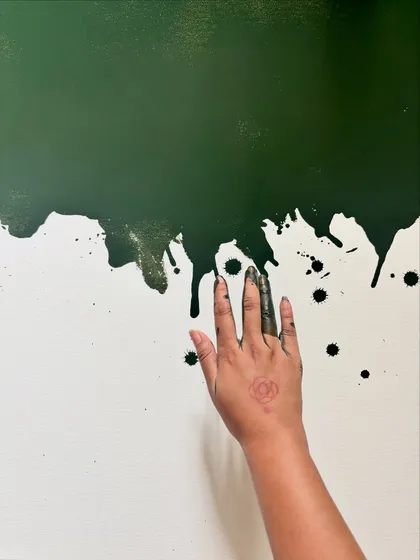 My hand, stained with paint, against a canvas of dripping green. This image is about the tactile, messy, and deeply personal connection between the artist and their materials.