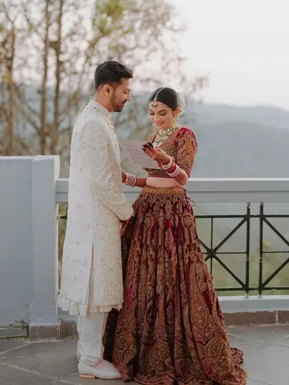 A candid moment between the bride and groom. Her makeup is whisper-light, letting her natural beauty shine, proving that less can be everything for a bridal look.