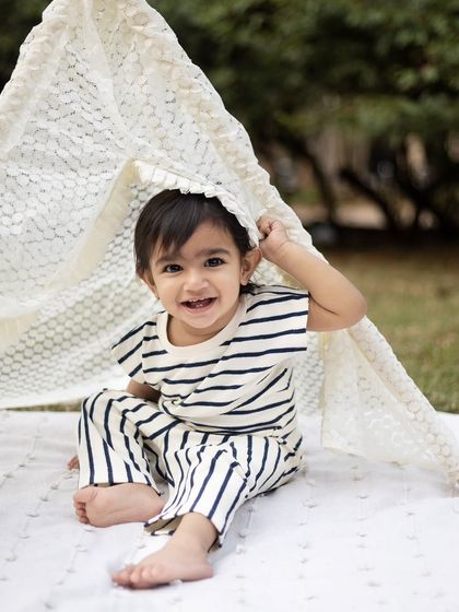 A playful peek-a-boo moment from under the teepee tent. Capturing these spontaneous moments of joy is what it's all about.