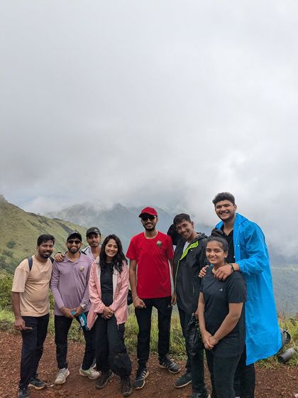 A group of friends posing on the misty trails of Kodachadri.