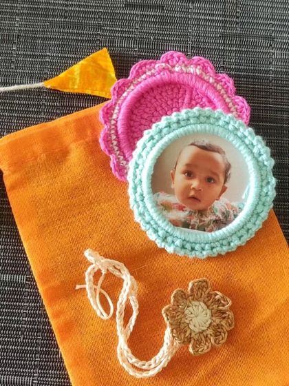 This Rakhi hamper includes personalized photo frame rakhis and a floral tie, making it a truly unique and heartfelt gift for your sibling.