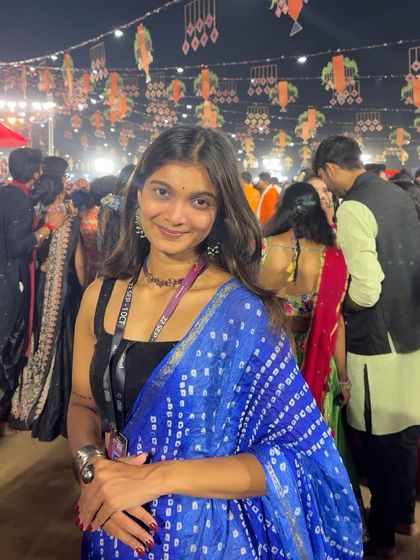 Posing amidst the beautiful decorations at a Navratri event. The atmosphere is just as important as the music.