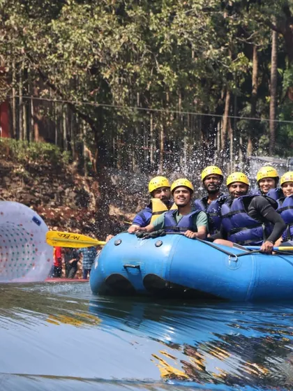 Our rafting boat passing by a zorbing ball, showing the variety of water sports available.