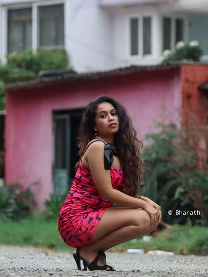 A full view of the urban setting, with the subject posed confidently in the foreground.