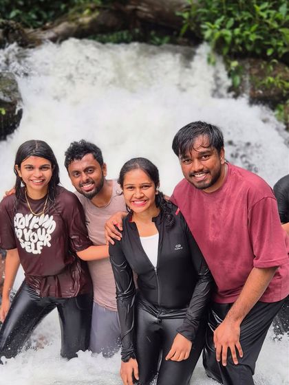 Friends having a blast in a natural pool during the Kudremukha trek. It's the perfect way to refresh and have some fun.