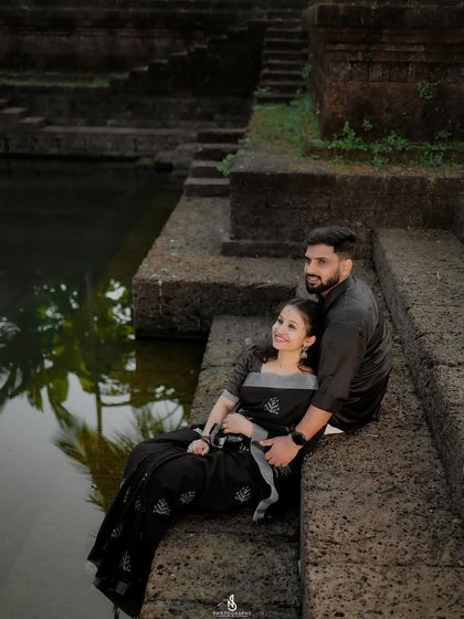 A serene moment by the temple pond (kalyani). The reflection of the palm trees in the water adds a beautiful, peaceful element.