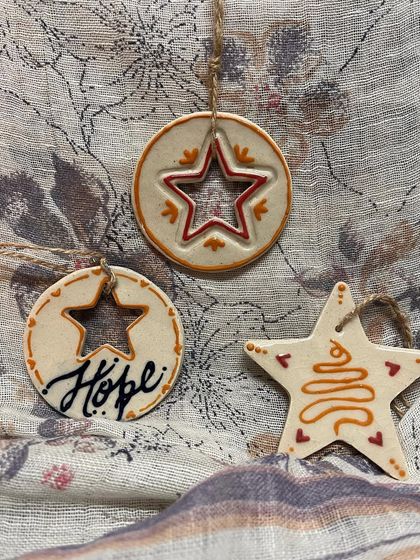 A set of three handmade ceramic ornaments, perfect for creating a cohesive look on your tree.