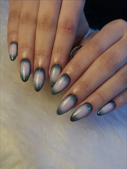 This is one of our most requested styles, a sleek and chic ombré effect. We created this glossy, gradient look on almond-shaped extensions, blending a smoky grey into a soft, milky base for a sophisticated finish.